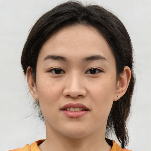 Joyful asian young-adult female with medium  brown hair and brown eyes