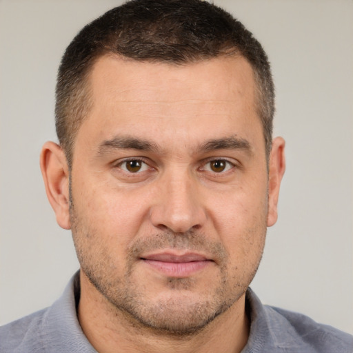 Joyful white adult male with short  brown hair and brown eyes