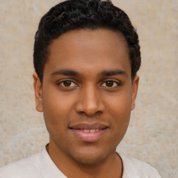 Joyful latino young-adult male with short  brown hair and brown eyes