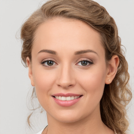 Joyful white young-adult female with medium  brown hair and blue eyes