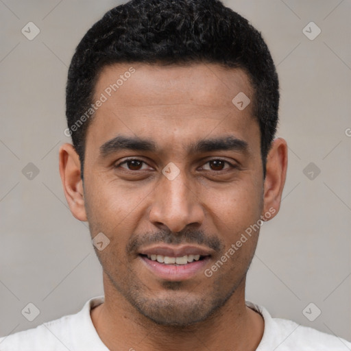 Joyful latino young-adult male with short  black hair and brown eyes