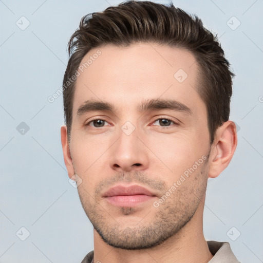 Neutral white young-adult male with short  brown hair and brown eyes