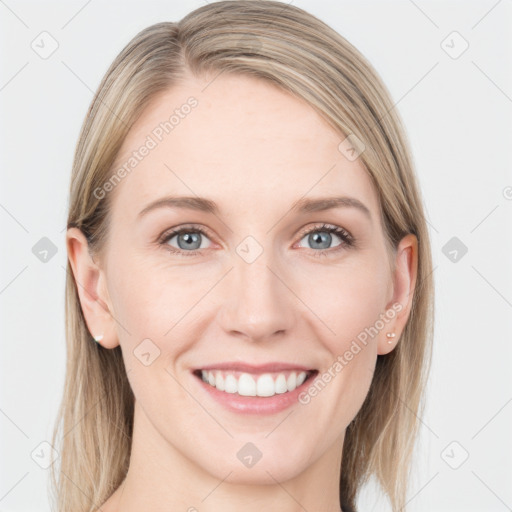 Joyful white young-adult female with long  brown hair and blue eyes