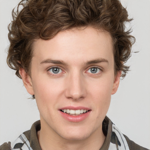 Joyful white young-adult male with short  brown hair and blue eyes