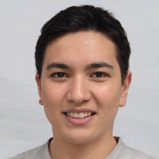 Joyful asian young-adult male with short  brown hair and brown eyes