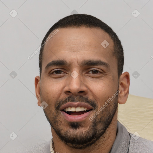 Joyful white young-adult male with short  black hair and brown eyes