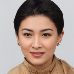 Joyful asian young-adult female with short  brown hair and brown eyes