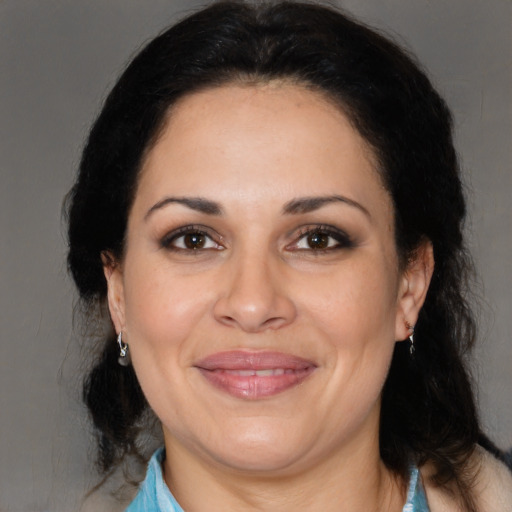 Joyful latino adult female with medium  brown hair and brown eyes