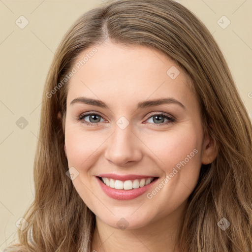 Joyful white young-adult female with long  brown hair and green eyes