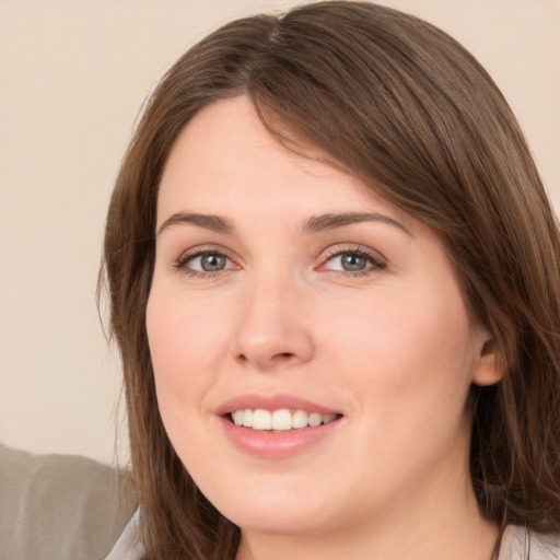 Joyful white young-adult female with medium  brown hair and green eyes