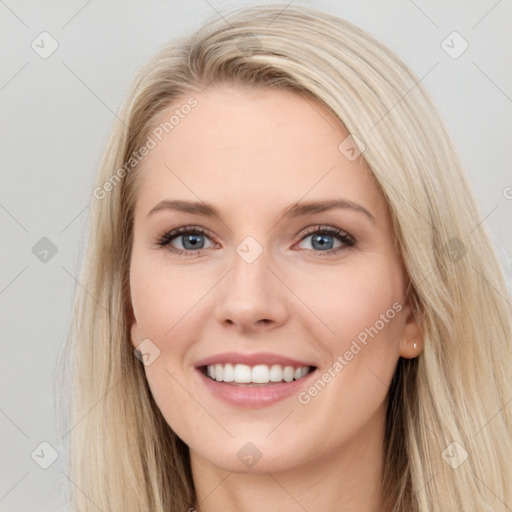 Joyful white young-adult female with long  brown hair and blue eyes