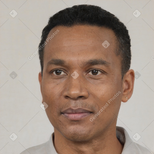 Joyful black adult male with short  black hair and brown eyes