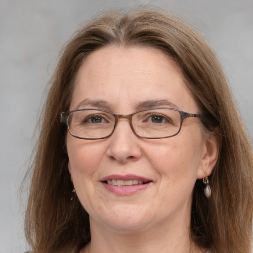 Joyful white middle-aged female with medium  brown hair and grey eyes