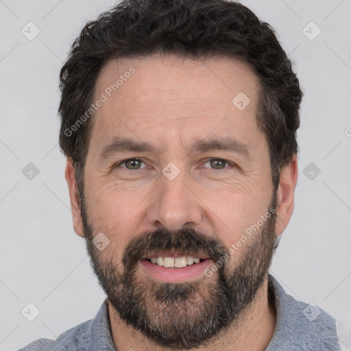 Joyful white adult male with short  black hair and brown eyes