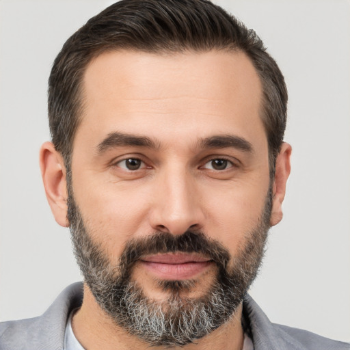 Joyful white adult male with short  brown hair and brown eyes