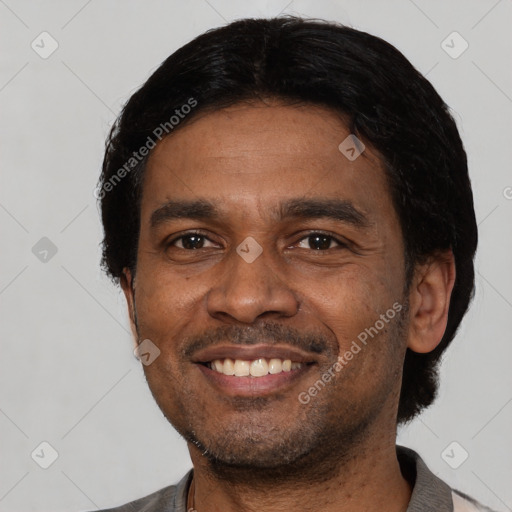 Joyful black adult male with short  black hair and brown eyes