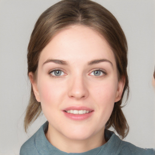 Joyful white young-adult female with medium  brown hair and blue eyes