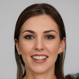 Joyful white young-adult female with long  brown hair and grey eyes