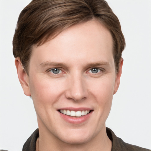 Joyful white young-adult female with short  brown hair and grey eyes