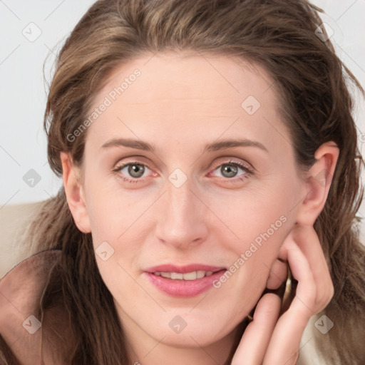 Joyful white young-adult female with long  brown hair and blue eyes