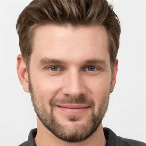 Joyful white young-adult male with short  brown hair and grey eyes