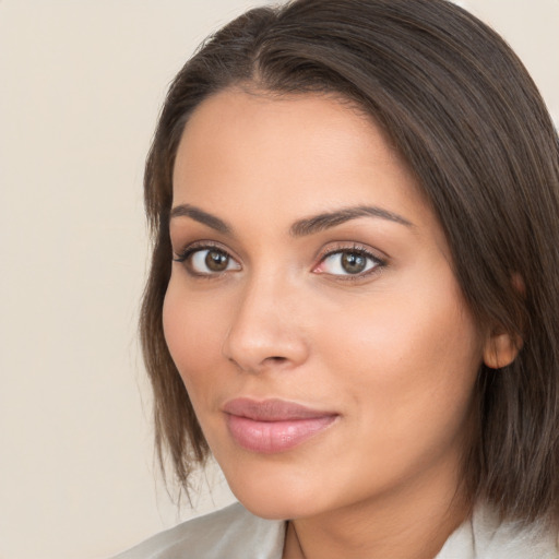 Joyful white young-adult female with medium  brown hair and brown eyes