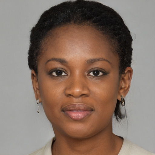 Joyful black young-adult female with short  brown hair and brown eyes