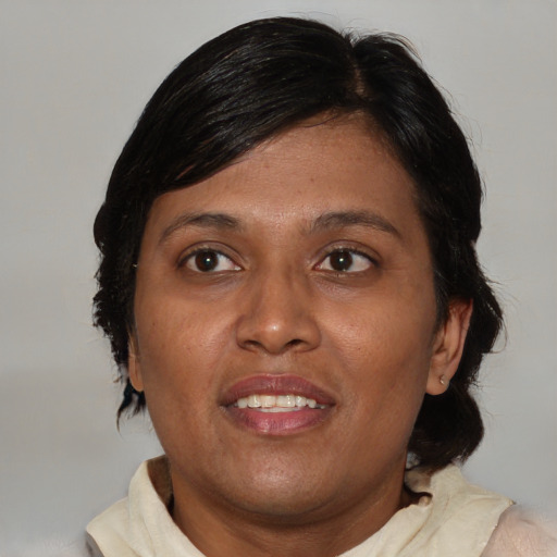 Joyful asian adult female with medium  brown hair and brown eyes