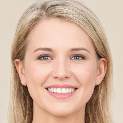 Joyful white young-adult female with long  brown hair and blue eyes