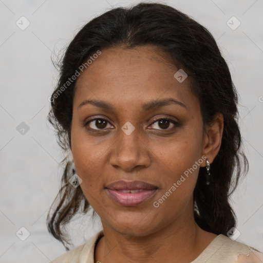 Joyful black adult female with medium  brown hair and brown eyes