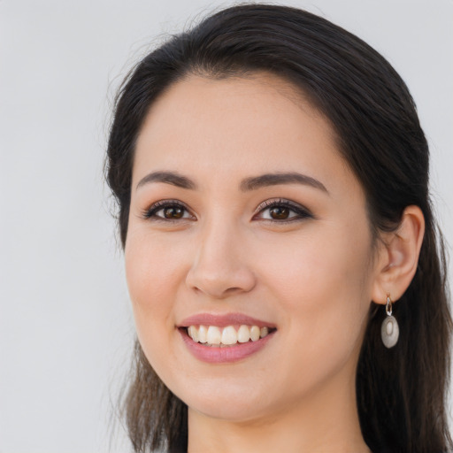 Joyful latino young-adult female with long  brown hair and brown eyes