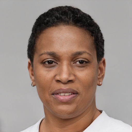 Joyful black adult female with short  black hair and brown eyes