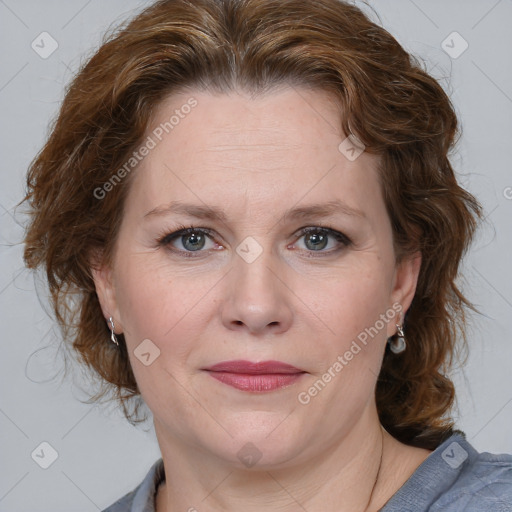 Joyful white adult female with medium  brown hair and blue eyes