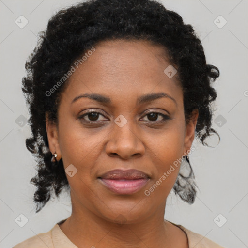 Joyful black adult female with short  brown hair and brown eyes