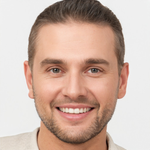 Joyful white young-adult male with short  brown hair and brown eyes