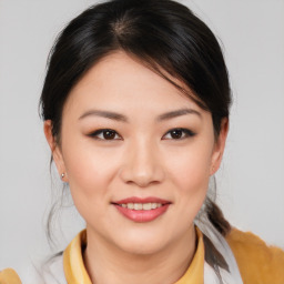 Joyful asian young-adult female with medium  brown hair and brown eyes