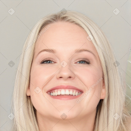 Joyful white adult female with long  brown hair and blue eyes