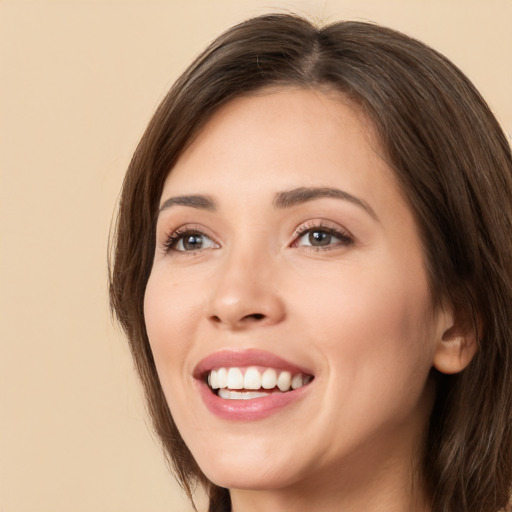 Joyful white young-adult female with long  brown hair and brown eyes