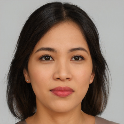 Neutral latino young-adult female with medium  brown hair and brown eyes