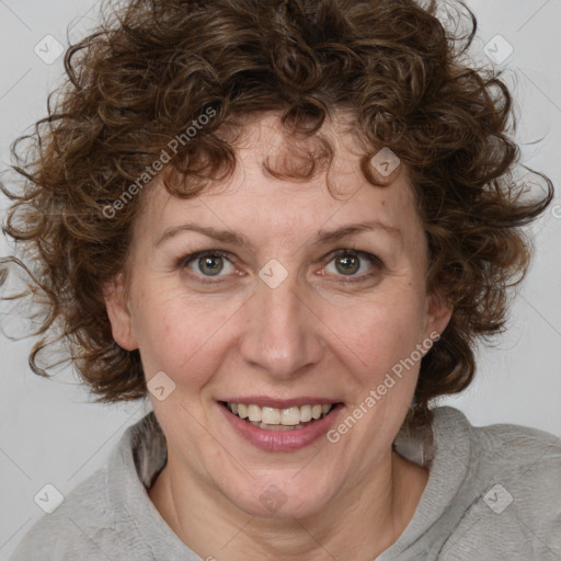 Joyful white adult female with medium  brown hair and blue eyes