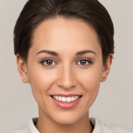 Joyful white young-adult female with short  brown hair and brown eyes