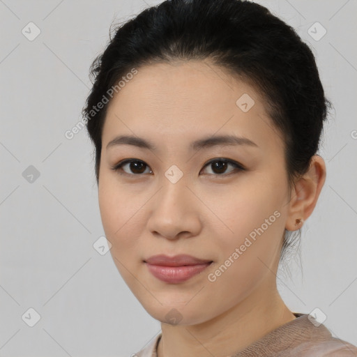 Joyful asian young-adult female with short  black hair and brown eyes