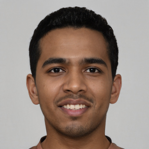 Joyful latino young-adult male with short  black hair and brown eyes