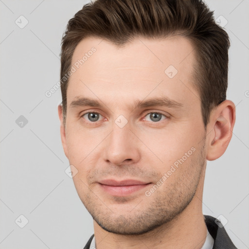 Joyful white young-adult male with short  brown hair and brown eyes