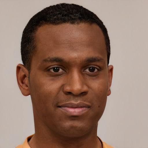 Joyful latino young-adult male with short  brown hair and brown eyes