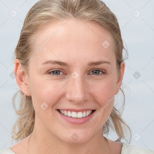 Joyful white young-adult female with medium  brown hair and blue eyes