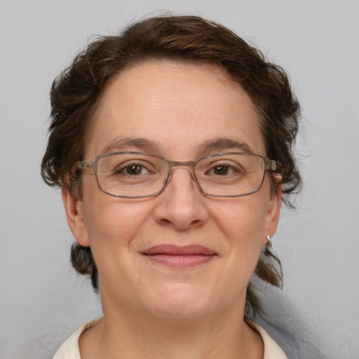 Joyful white middle-aged female with medium  brown hair and brown eyes