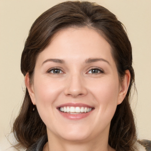 Joyful white young-adult female with medium  brown hair and brown eyes