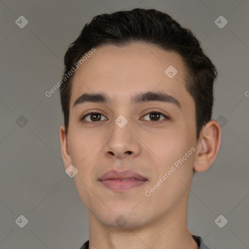 Joyful white young-adult male with short  black hair and brown eyes