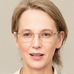 Joyful white adult female with medium  brown hair and blue eyes